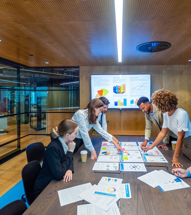 Team reviewing charts in a conference room.